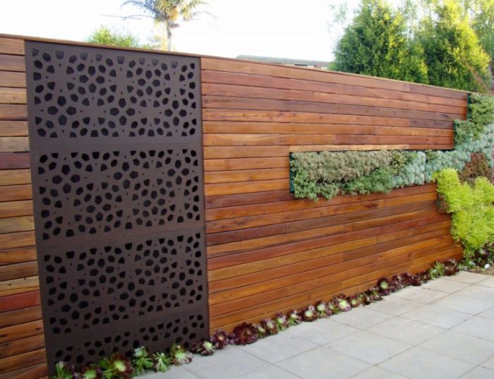 Класичне поєднання дерева і металу дозволило створити незвичайний комбінований паркан.